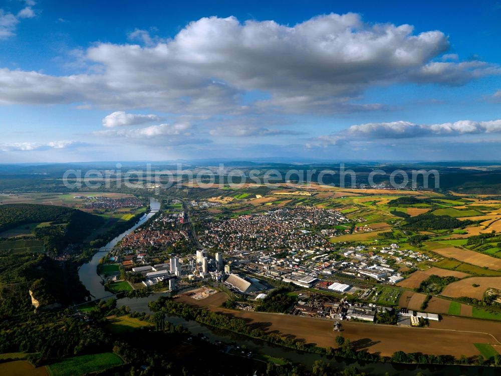 Karlstadt from above - Town view of Karlstadt on Main in the state of Bavaria. The South of the town, located directly on the riverbank, is characterised by three large industrial companies: iron works Duerker, cement factory Schwenk and the veneer company Kohl. The town centre is located behind this industrial area and surrounded by the fields and landscape of the main-franconian wine region