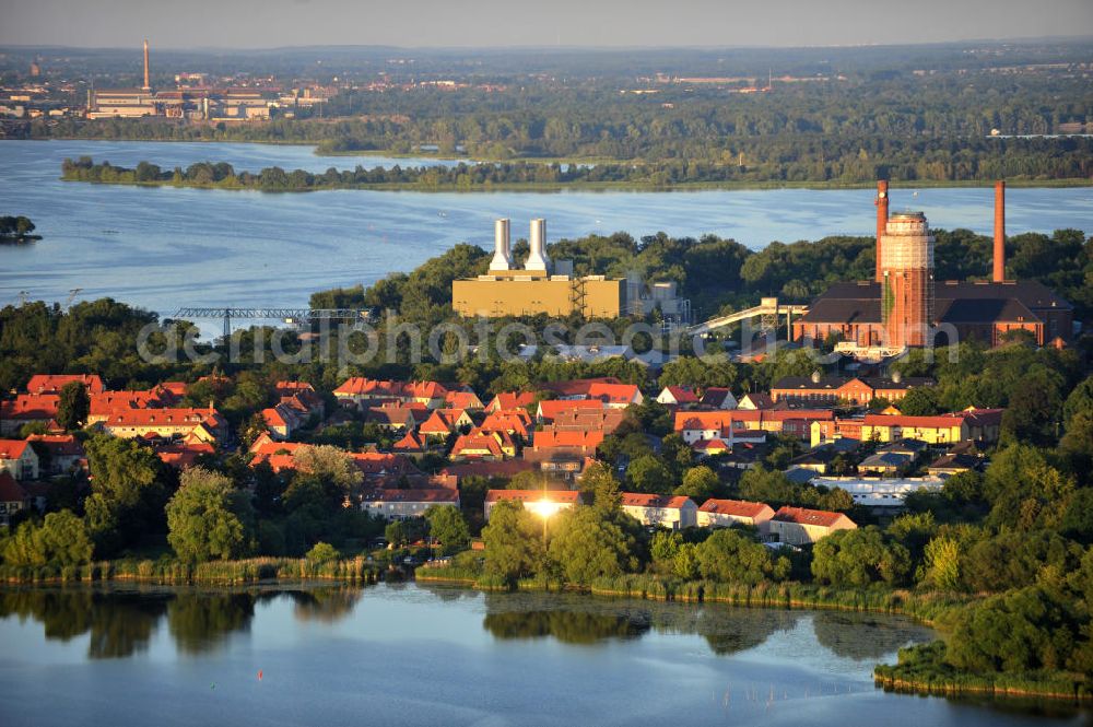 Brandenburg - Kirchmöser from above - Stadtansicht des Stadteils Kirchmöser, Brandenburg an der Havel. Hinter den Wohngebieten am Uferbereich das von e.on betriebene Gaskraftwerk mit dem weithin sichtbaren Wasserturm. Die Halbinsel liegt im Plauer See. Cityscape of Brandenburg Kirchmoeser. On the picture the gas power station by e.on that produces energy for the and the water tower, which reminds of the former gunpowder factory. The peninsula is located in the Plauer lake.