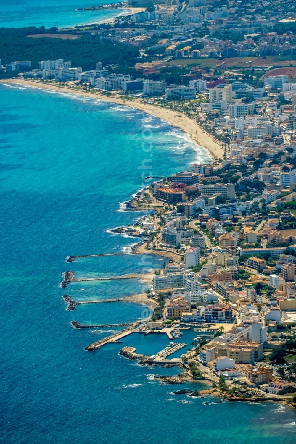 Aerial image Cala Bona - City view on sea coastline with the local port facilities in Cala Bona in Balearic island of Mallorca, Spain