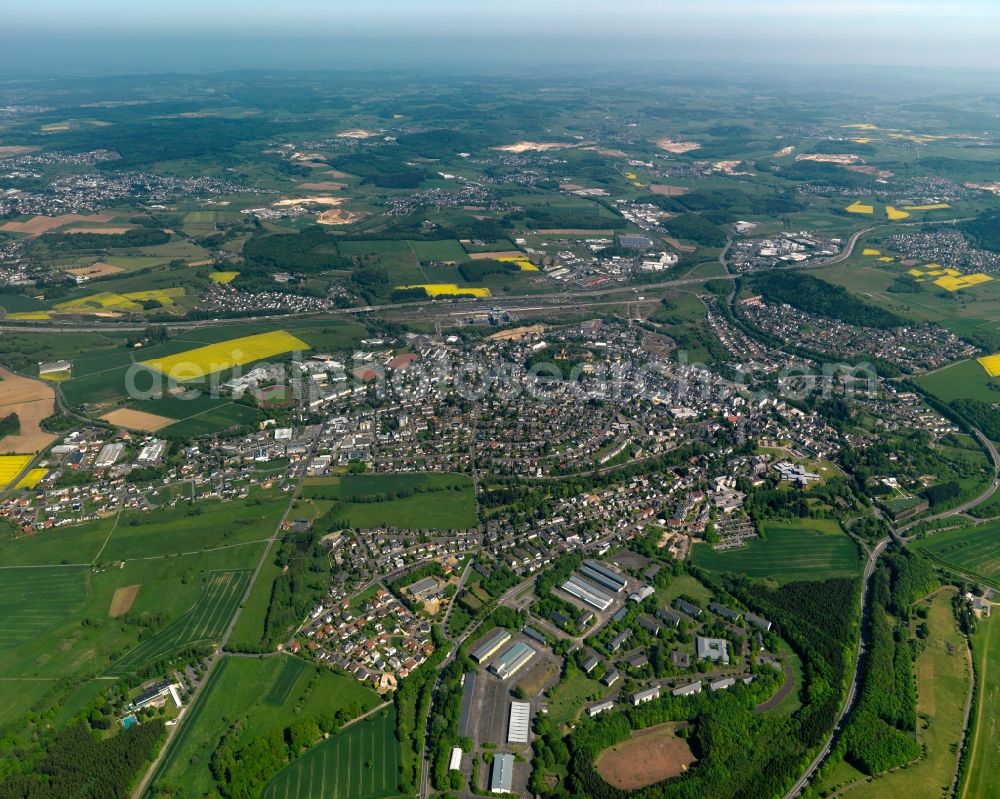 Montabaur from the bird's eye view: View of the town of Montabaur in the state Rhineland-Palatinate. The official tourist resort is the seat of administration of the county district of Westerwald. The town is an economic centre of the region and know for its castle and train station. The federal motorway A8 takes its course in the North of the town