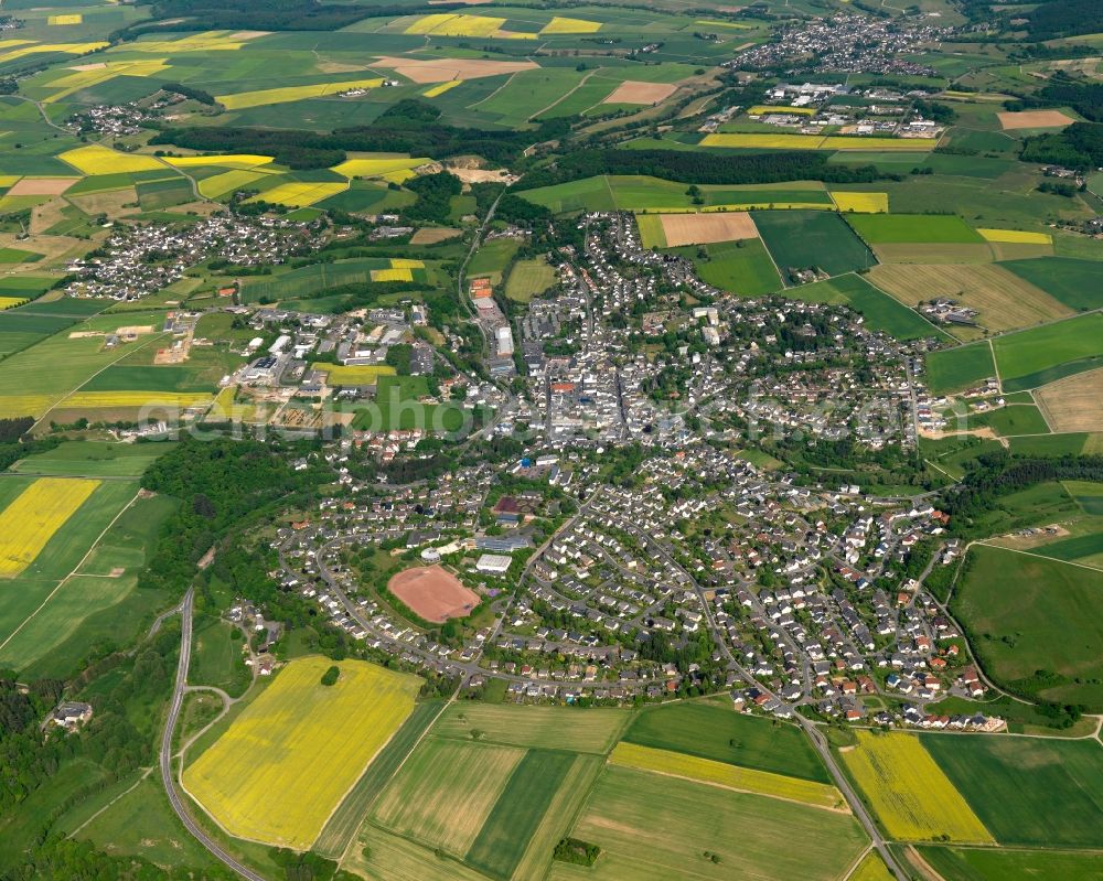 Aerial photograph Nastätten - View of the town of Nastaetten in the state of Rhineland-Palatinate. The official tourist resort is located in the county district of Rhine-Lahn, in the Western Hintertaunus mountain region and is the centre of the so-called Blue Country. The town consists of residential areas, includes an industrial area and is surrounded by rapeseed fields and meadows