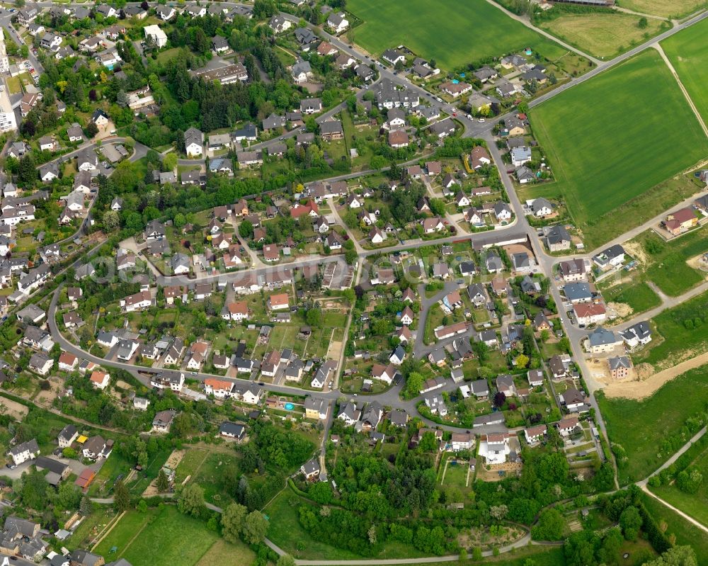 Aerial photograph Nastätten - View of the town of Nastaetten in the state of Rhineland-Palatinate. The official tourist resort is located in the county district of Rhine-Lahn, in the Western Hintertaunus mountain region and is the centre of the so-called Blue Country. The town consists of residential areas, is located on federal highway B274 and is surrounded by rapeseed fields and meadows