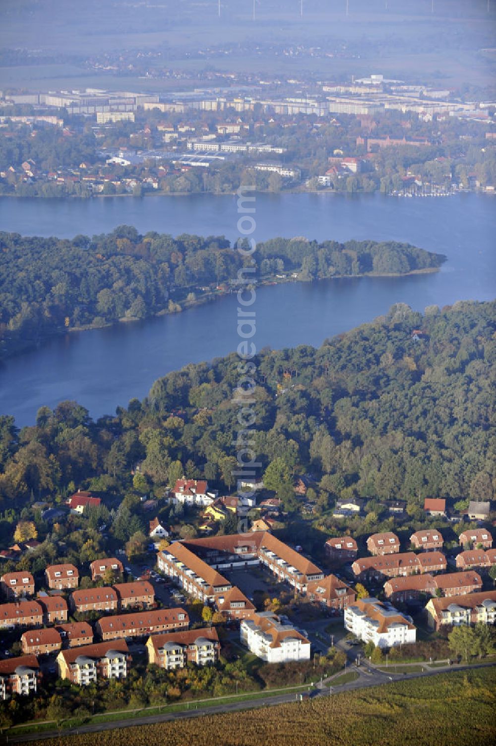 Neuruppin from the bird's eye view: Blick über das Wohngebiet Lindenzentrum auf den Ruppiner See und die Stadt Neuruppin in Brandenburg. View over the housing area Lindenzentrum to the lake Ruppin and the city of Neuruppin in Brandenburg.