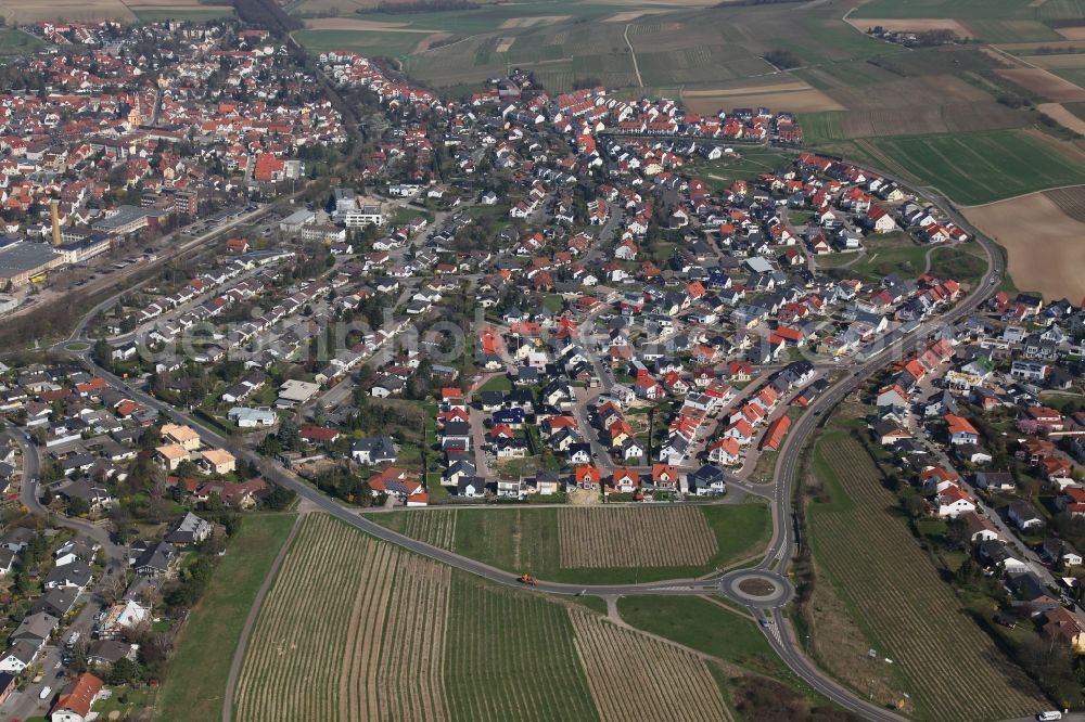 Nieder-Olm from the bird's eye view: View of Nieder-Olm in the state Rhineland-Palatinate. The town is located in the county district of Mainz-Bingen, in the region of Mainzer Becken. The urban area consists of wooded residential areas and single family houses and is surrounded by fields. Nieder-Olm is located adjacent to the federal motorway A63 and includes a wide industrial area in the West of the town