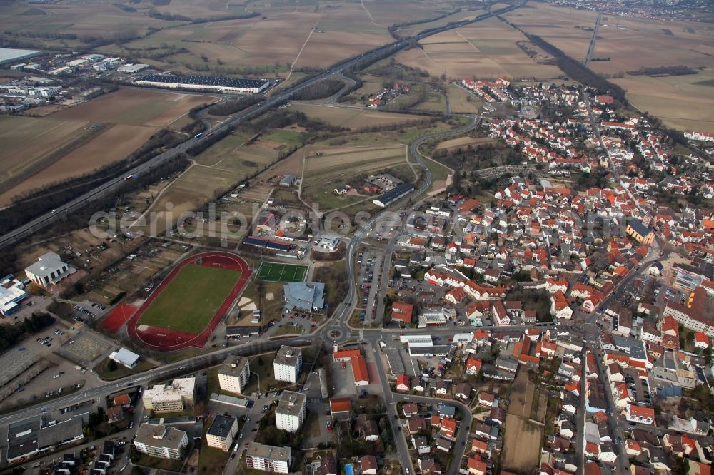 Nieder-Olm from the bird's eye view: View of Nieder-Olm in the state Rhineland-Palatinate. The town is located in the county district of Mainz-Bingen, in the region of Mainzer Becken. The urban area consists of wooded residential areas and single family houses and is surrounded by fields. Nieder-Olm is located adjacent to the federal motorway A63 and includes a wide industrial area in the West of the town