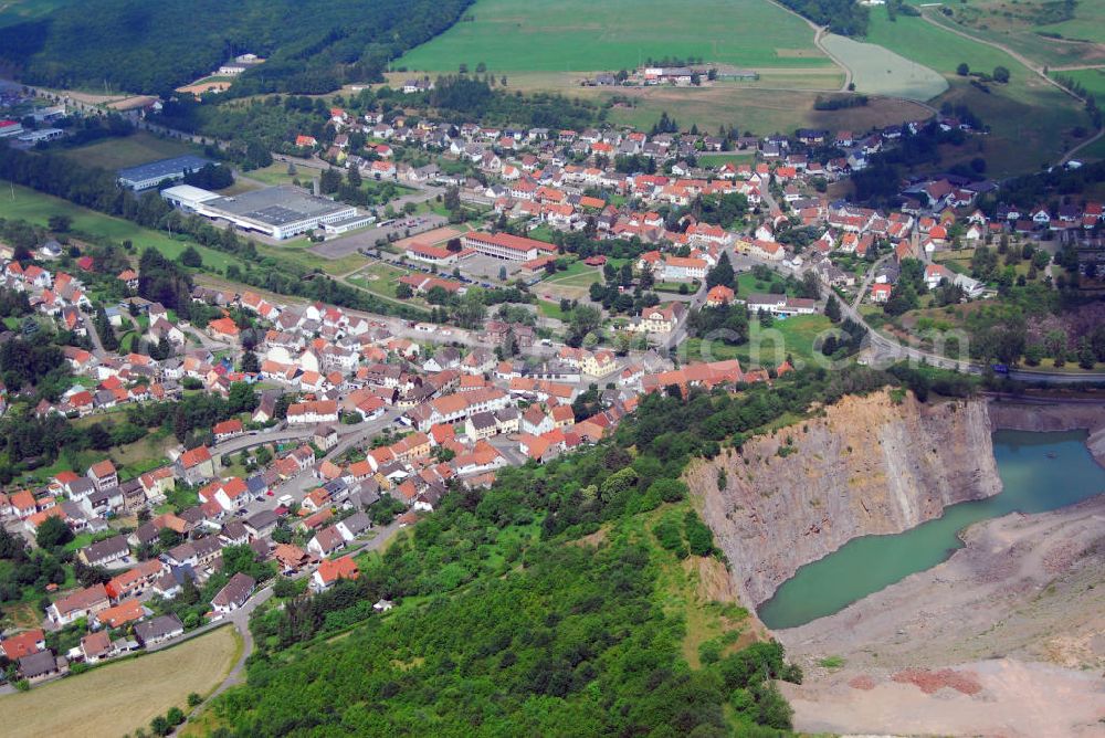 Aerial image Altenglan / OT Rammelsbach - Blick über den Steinbruch auf die Gemeinde Rammelsbach. Rammelsbach ist eine Ortsgemeinde im Landkreis Kusel. Der Industrieort ist durch seinen 50 ha großen Melaphyrsteinbruch bekannt, in dem seit über 100 Jahren Hartsteine gewonnen und verarbeitet werden. Am oberen Bildrand ist die RME Manufacturing GmbH zu sehen. Die RME Manufacturing GmbH ist die deutsche Tochtergesellschaft der RITEK Corporation, dem weltweit führenden Produzenten digitaler Speichermedien. Kontakt: RME Manufacturing GmbH, Glanstr. 33, 66887 Rammelsbach, Tel.: 063814 260,