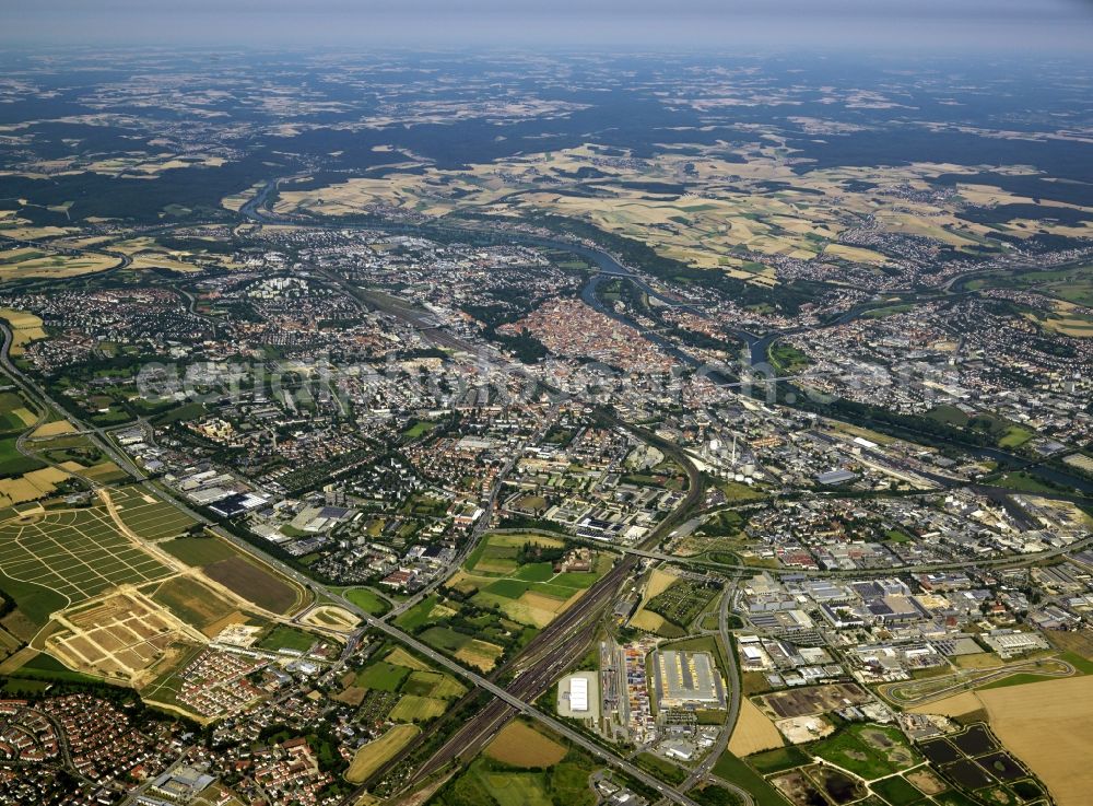 Aerial photograph Regensburg - Panoramic view of downtown Regensburg in the state of Bavaria. The city is crossed by the river Danube in West-East direction. The river includes two islands at the historic city centre. View from the Southeast to the North. In the South, the federal motorway A100 passes the city