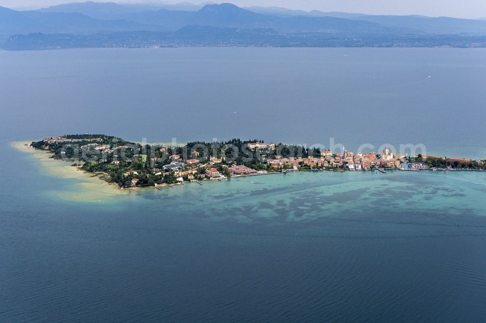 Sirmione from above - City view of Sirmione in the province Brescia in Italy. The city is next to the south bank at the gardasee. In the right corner stands the Sirmione castle. On the horizon the mountains and other citys are visible