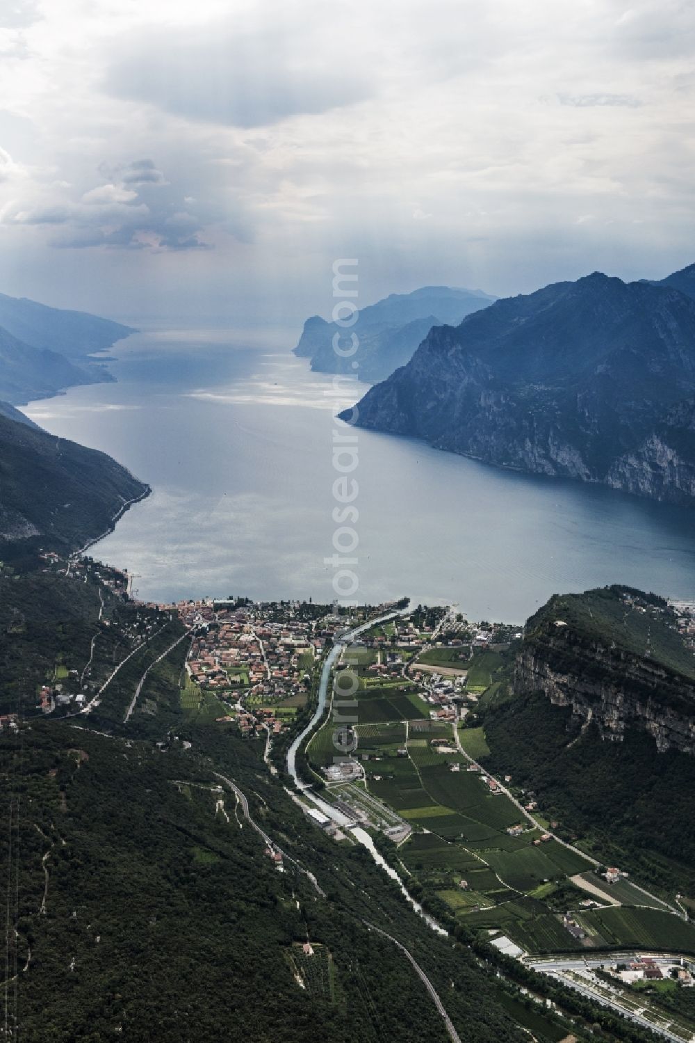Naag-Turbel from above - City view of Torbole at the northern bank of the Gardasee in the province Trient in Italy. The city and the Gardasee are surrounded by mountains. The Sarca flows through the city