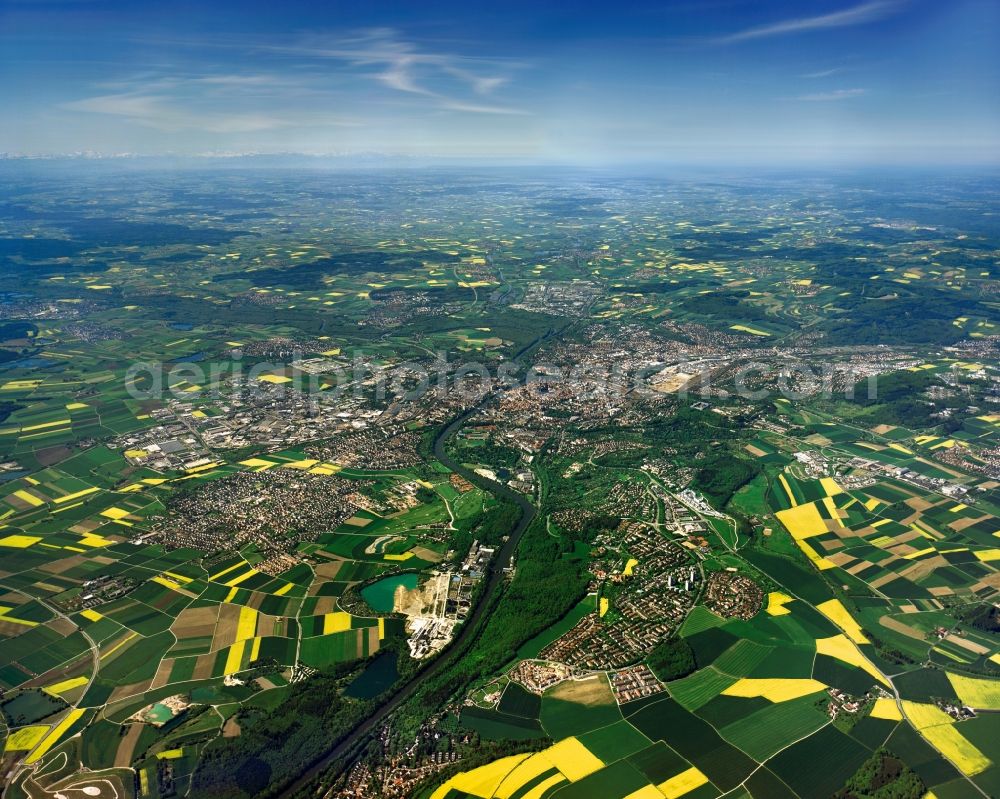 Ulm from the bird's eye view: Cityscape of the towns of Ulm, Neu-Ulm and the surrounding landscape in the state of Baden-Wuerttemberg. View from the North East to the Southwest. Neu-Ulm is located south of the river Danube, Ulm is located north of it. Visible in the background are tha Alps. The riverbank and valley of the Danube is characterised by agricultural spaces and fields, small hamlets and villages as well as a variety of lakes