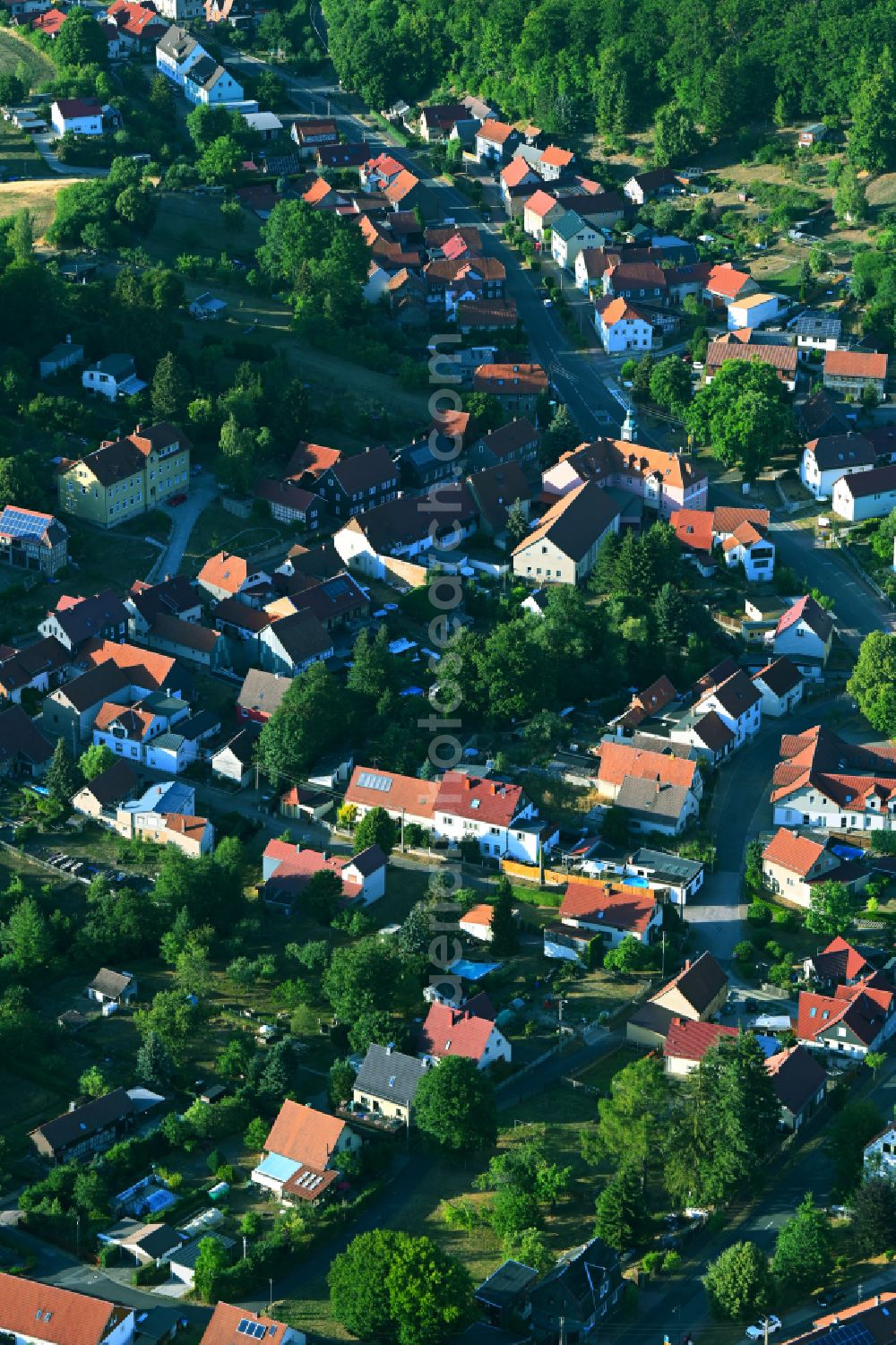 Martinroda from above - City view of the inner city area in the valley surrounded by mountains in Martinroda in the state Thuringia, Germany