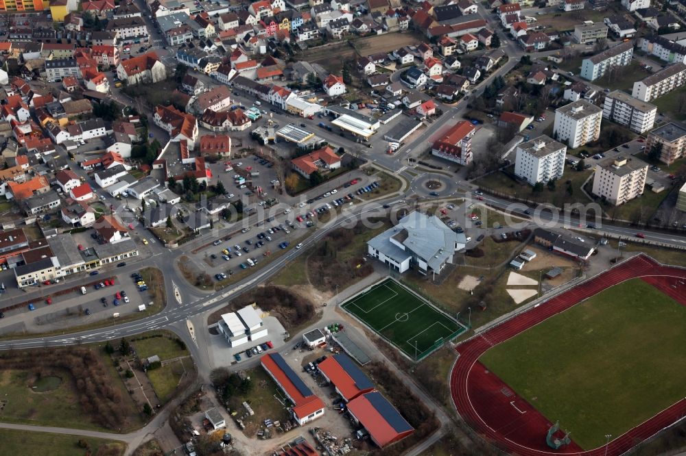 Nieder-Olm from the bird's eye view: View of the West of the town centre of Nieder-Olm in the state Rhineland-Palatinate. The town is located in the county district of Mainz-Bingen, in the region of Mainzer Becken. The urban area consists of wooded residential areas and single family houses and is surrounded by fields. The West of the town centre borders on the federal motorway A63 and is home to sports grounds and facilities