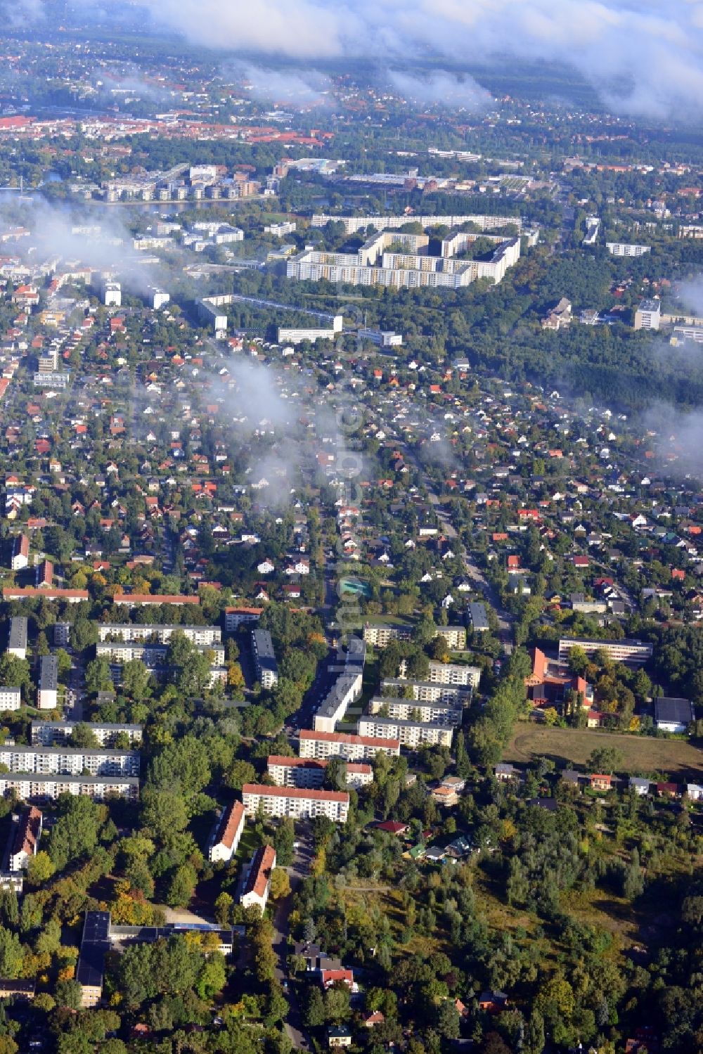 Aerial photograph Berlin - Cityscape traversed by clouds overlooking the autumnal district of Koepenick along residential areas and green space along Wendenschlossstrasse with a view of the plattenbau settlement Allende-Viertel in Berlin