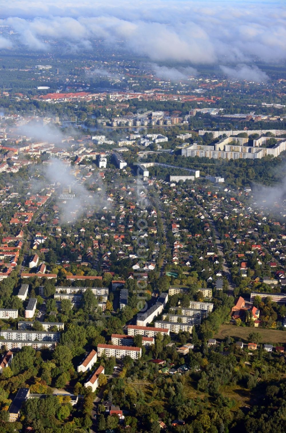 Berlin from above - Cityscape traversed by clouds overlooking the autumnal district of Koepenick along residential areas and green space along Wendenschlossstrasse with a view of the plattenbau settlement Allende-Viertel in Berlin