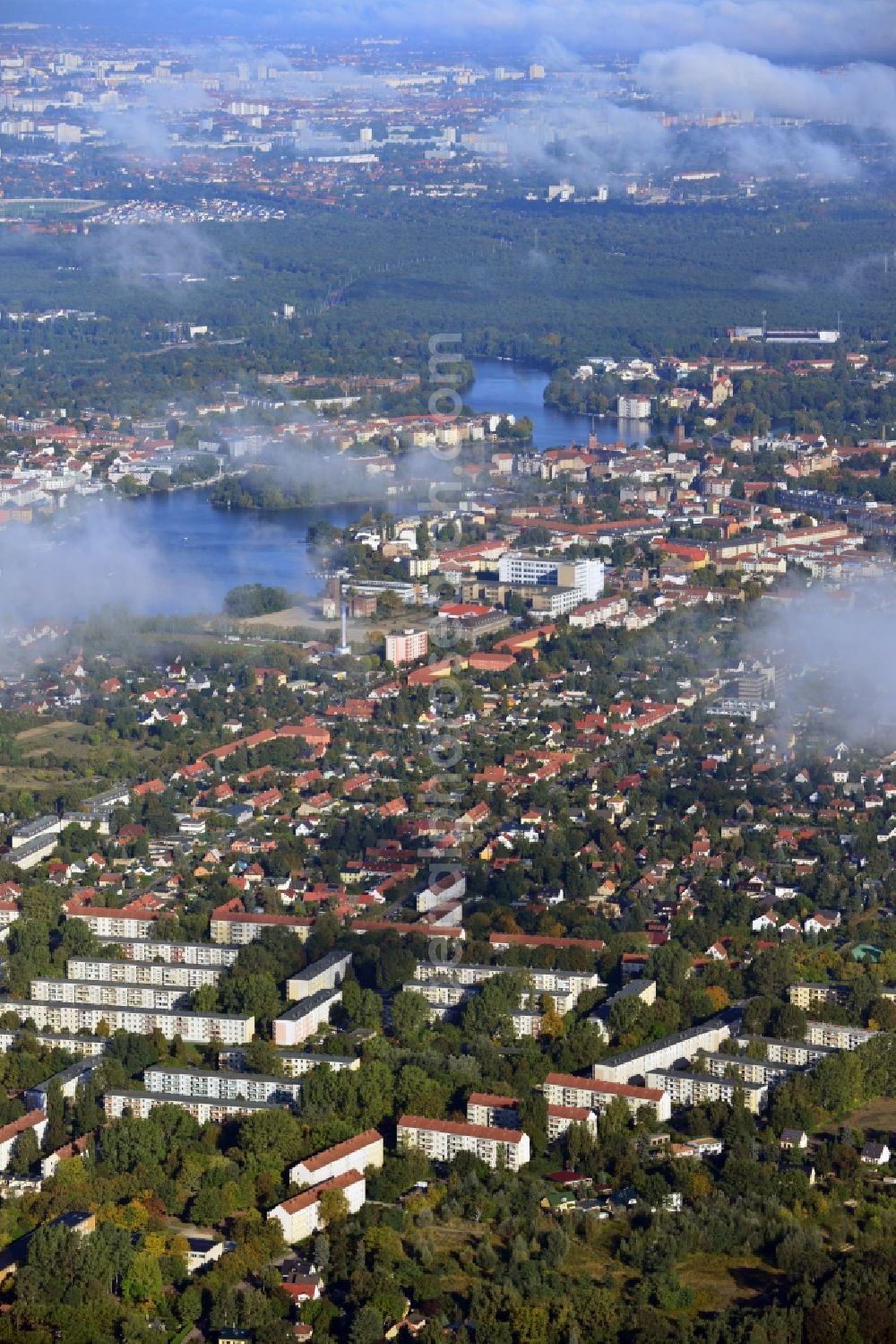 Berlin from the bird's eye view: Cityscape traversed by clouds overlooking the autumnal district of Koepenick along residential areas and green space along Wendenschlossstrasse and the river Dahme with a view of Wuhlheide in Berlin