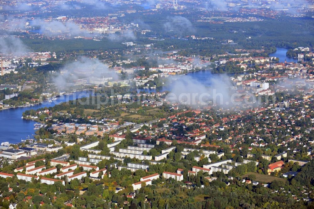 Berlin from above - Cityscape traversed by clouds overlooking the autumnal district of Koepenick along the river Dahme witha view of the Rohrwall-Island in Berlin. Residential areas and green space along Wendenschlossstrasse