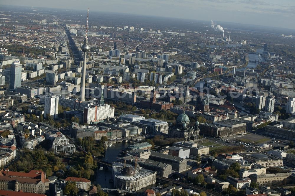 Aerial photograph Berlin - The city's central Mitte district of Berlin in the state of Berlin is influenced by a variety of attractions. The dominant feature of the city center East Alexanderplatz, the Berlin Television Tower with its restaurant and observation deck below the transmitter tower. In his environment are St. Mary's Church, the Red City Hall, the Old Town House and St. Nicholas Church. On the UNESCO World Heritage Museum Island are world-famous museums such as the Bode Museum, Pergamon Museum, the Old Museum, the New Museum and the Old National Gallery. The Berliner Dom completes the ensemble of buildings. At the time of recording much construction took place in the city center. The Palace of the Republic, a large representative building of the GDR was not demolished