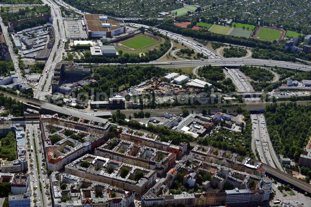 Berlin from the bird's eye view: The area in the vicinity of Sachsendamm in the Schoeneberg district of Berlin is an important transport hub of Berlin. The branch Zehlendorf connects the motorway A100 to the southern districts. In addition to the city ring run the tracks of the S-Bahn ring. The picture shows the S-Bahnhof Schoeneberg. Amidst the roads the furniture store Moebel Kraft was built in a prominent place. In its vicinity are the Dominicus sports field and training grounds of the Berlin gymnastic and recreational waistband at the Vorarlberg dam