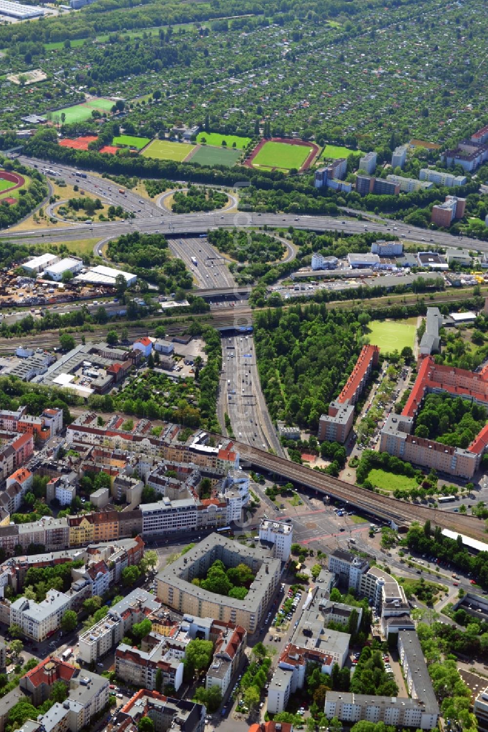 Aerial photograph Berlin - Das Gebiet um den Insbrucker Platz im Stadtbezirk Schöneberg von Berlin ist ein wichtiger Verkehrsknotenpunkt von Berlin. Der Abzweig Zehlendorf verbindet die Bundesautobahn A100 mit den südlichen Stadtbezirken. Hier verlaufen die Gleise des S-Bahn-Ring und kreuzen mehrere Hauptverkehrsstraßen. Im Bild zu sehen ist der S-Bahnhof Innsbrucker Platz. Im Nahbereichder Verkehrswege befinden sich die Trainingsplätze des Berliner Turn- und Freizeitbund am Vorarlberger Damm. Nördliche der Verkehrsanbindungen schließen sich die attraktiven Wohngebiete der Schöneberger Altstadt an.// The area around the Insbrucker place in the Schoeneberg district of Berlin is an important transport hub of Berlin. The branch Zehlendorf connects the motorway A100 to the southern districts. Here, the tracks run the S-Bahn ring and cross several major roads. In the picture you see is the place Innsbruck S-Bahn station. In the vicinity of roads, the training grounds of the Berlin gymnastic and recreational covenant are the Vorarlberg dam. North of transport links close to the residential areas of the atractive Nice's Old Town.