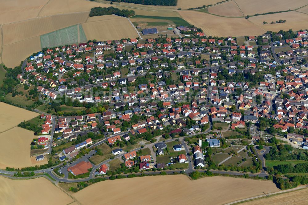 Eisingen from above - Urban area with outskirts and inner city area on the edge of agricultural fields and arable land in Eisingen in the state Bavaria, Germany