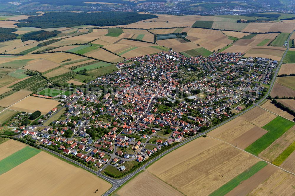 Aerial image Hettstadt - Urban area with outskirts and inner city area on the edge of agricultural fields and arable land in Hettstadt in the state Bavaria, Germany