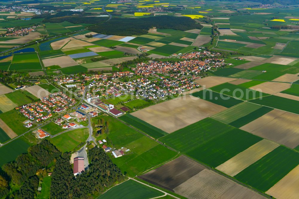 Kleinlangheim from the bird's eye view: Urban area with outskirts and inner city area on the edge of agricultural fields and arable land in Kleinlangheim in the state Bavaria, Germany