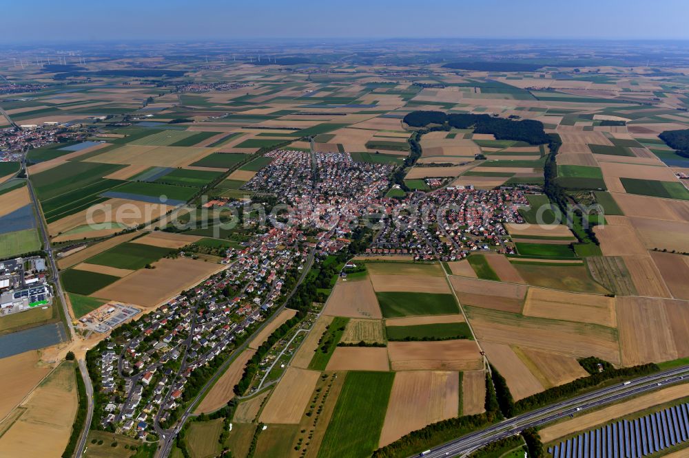 Kürnach from the bird's eye view: Urban area with outskirts and inner city area on the edge of agricultural fields and arable land in Kürnach in the state Bavaria, Germany