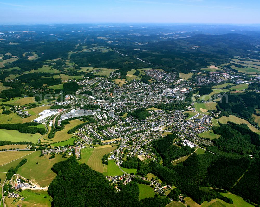 Meinerzhagen from the bird's eye view: Urban area with outskirts and inner city area on the edge of agricultural fields and arable land in Meinerzhagen in the state North Rhine-Westphalia, Germany