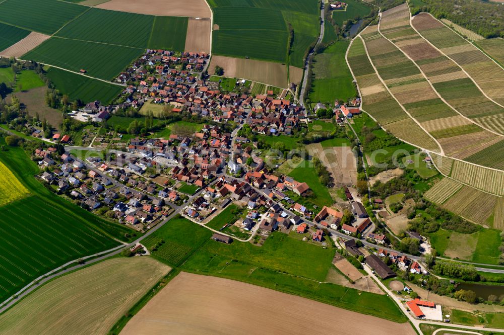 Obervolkach from the bird's eye view: Urban area with outskirts and inner city area on the edge of agricultural fields and arable land in Obervolkach in the state Bavaria, Germany