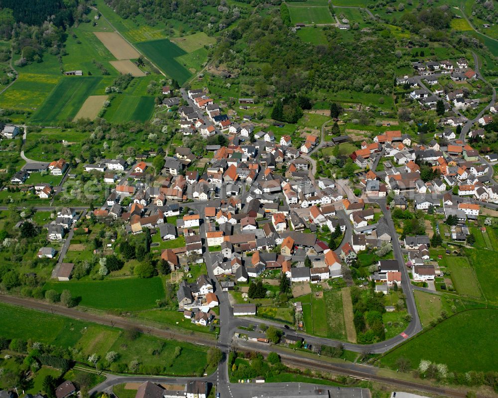 Saasen from above - Urban area with outskirts and inner city area on the edge of agricultural fields and arable land in Saasen in the state Hesse, Germany