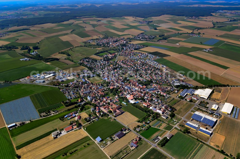 Unterpleichfeld from above - Urban area with outskirts and inner city area on the edge of agricultural fields and arable land in Unterpleichfeld in the state Bavaria, Germany