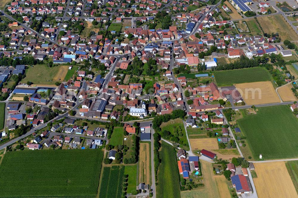 Unterpleichfeld from the bird's eye view: Urban area with outskirts and inner city area on the edge of agricultural fields and arable land in Unterpleichfeld in the state Bavaria, Germany