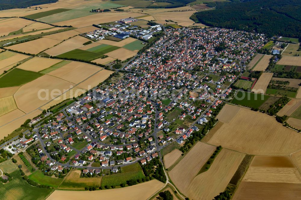 Waldbüttelbrunn from the bird's eye view: Urban area with outskirts and inner city area on the edge of agricultural fields and arable land in Waldbüttelbrunn in the state Bavaria, Germany