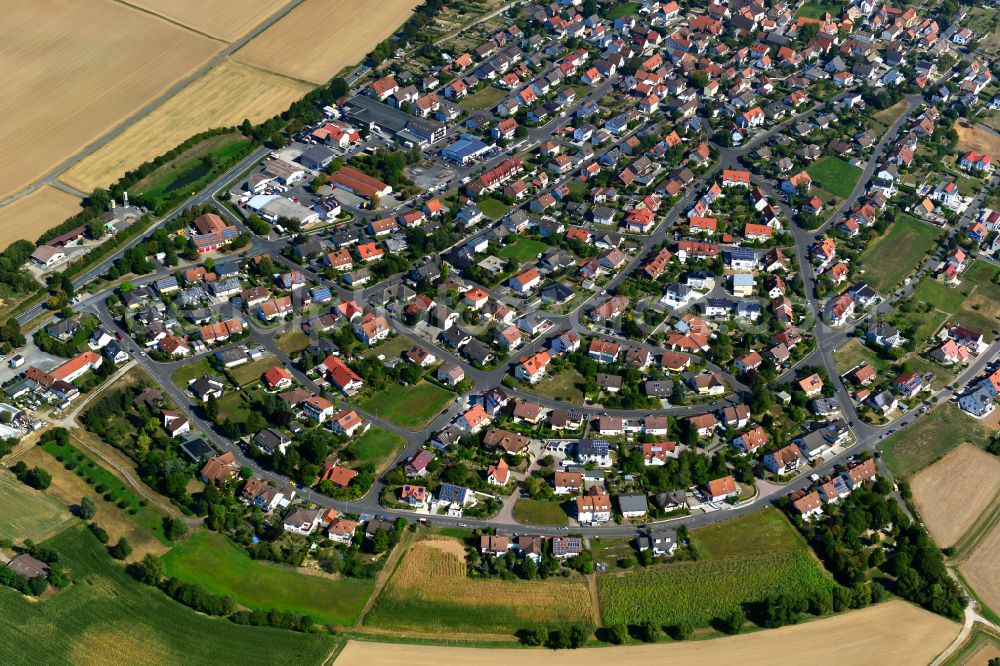 Aerial image Waldbüttelbrunn - Urban area with outskirts and inner city area on the edge of agricultural fields and arable land in Waldbüttelbrunn in the state Bavaria, Germany