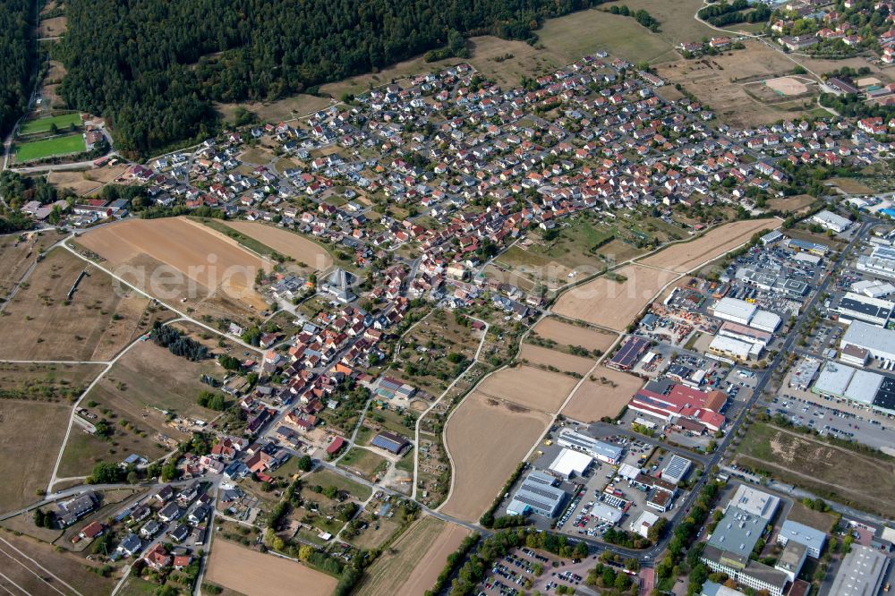 Aerial photograph Wombach - Urban area with outskirts and inner city area on the edge of agricultural fields and arable land in Wombach in the state Bavaria, Germany