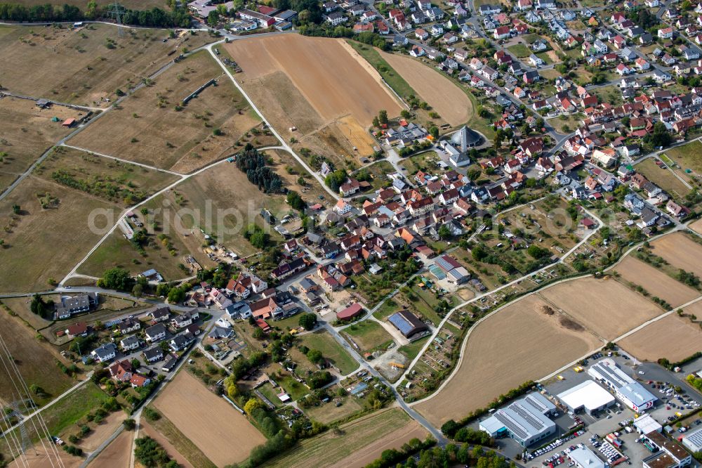 Wombach from above - Urban area with outskirts and inner city area on the edge of agricultural fields and arable land in Wombach in the state Bavaria, Germany