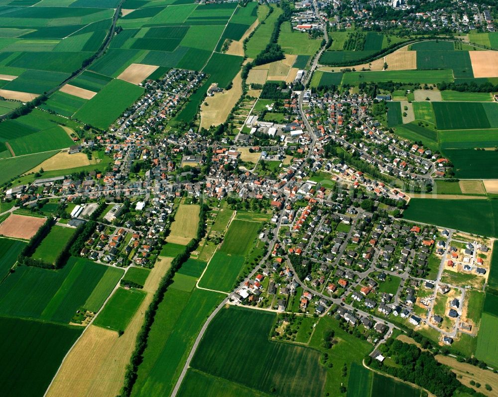 Würges from the bird's eye view: Urban area with outskirts and inner city area on the edge of agricultural fields and arable land in Würges in the state Hesse, Germany