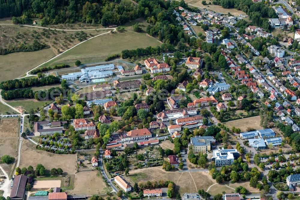 Wombach from above - City view from the outskirts with adjacent agricultural fields in Wombach in the state Bavaria, Germany