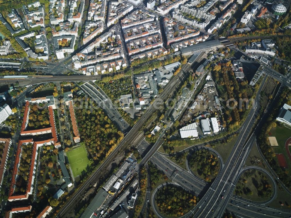 Berlin from the bird's eye view: District Schoeneberg with the motorway intersection federal road BAB A 100 - A 103 with the residential area along the Hauptstrasse - Ebersstrasse - Rubenstrasse in the city in Berlin. In the picture as well the suburban train station Schoeneberg with track system