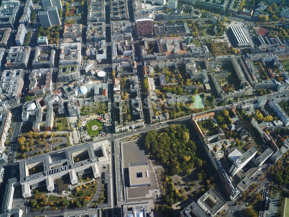 Aerial image Berlin - Quarter south of Leipziger Strasse in the Kreuzberg district of Berlin. Kochstrasse in the West becomes Rudi-Dutschke-Strasse in the East when meeting Friedrichstrasse. There are several important buildings located on Rudi-Dutschke-Strasse: the editorial offices of taz, the distinct colourful and bent GSW-Building and the Axel-Springer-Arcades with their eight courtyards. Several apartment high rises are located on Leipziger Strasse. The lower image area shows the Topography of Terror memorial and the Ministry of Finances