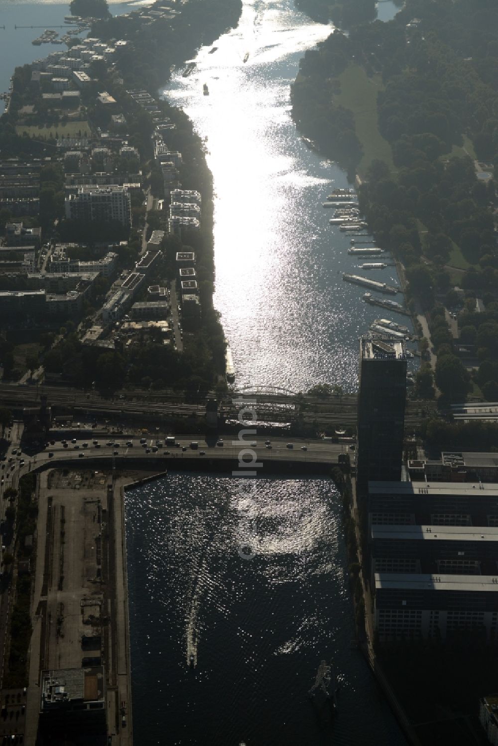 Berlin from above - View of the Alt-Treptow and Friedrichshain-Kreuzberg parts along the river Spree in Berlin in Germany. View from the West. The foreground shows the high rise building complex Treptowers as well as Elsenbruecke Bridge