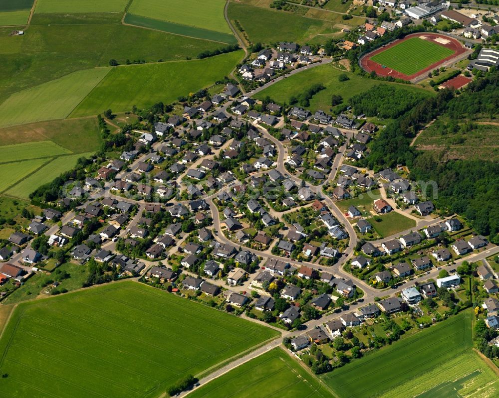 Aerial photograph Emmelshausen - View of the Basselscheid part of the town of Emmelshausen in the state of Rhineland-Palatinate. The town is an official spa resort in the county district of Rhine-Hunsrueck, surrounded by fields, meadows and forest