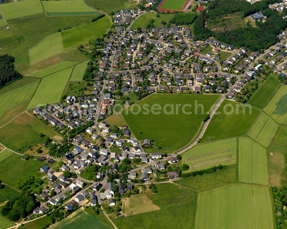 Emmelshausen from the bird's eye view: View of the Basselscheid part of the town of Emmelshausen in the state of Rhineland-Palatinate. The town is an official spa resort in the county district of Rhine-Hunsrueck, surrounded by fields, meadows and forest