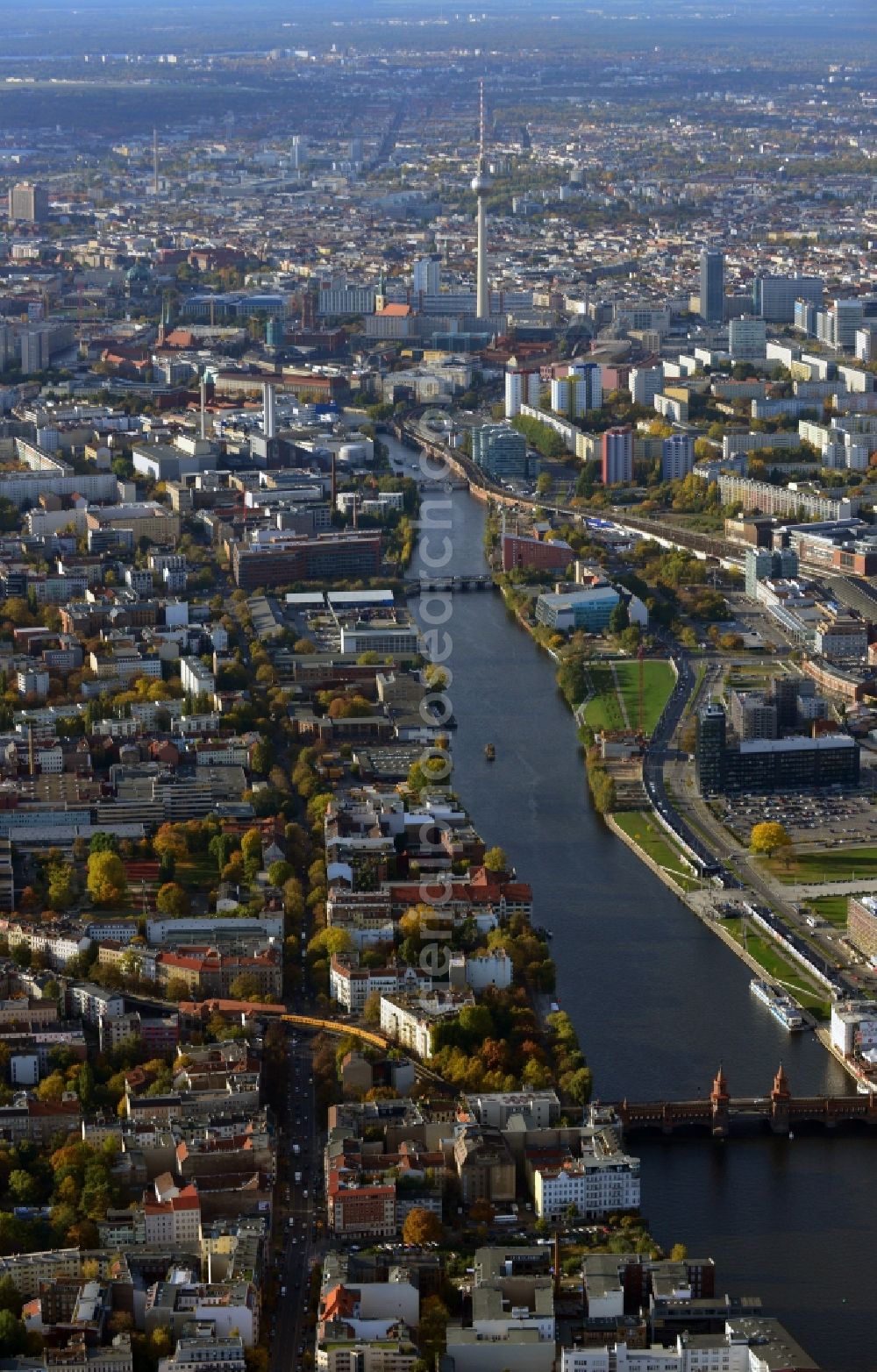 Aerial image Berlin - Cityscape of Berlin Friedrichshain along the river Spree leading towards the television tower. View of Oberbaumbruecke, residential and commercial areas as well as buildings and constrcution sites in the development area Mediaspree along the EastSideGallery