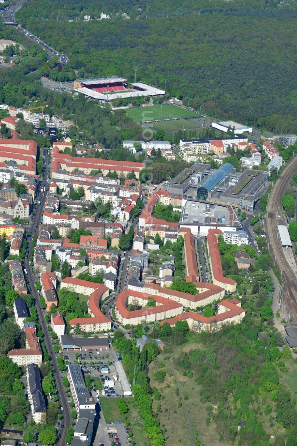 Berlin from the bird's eye view: View of the Berlin-Koepenick part of the district of Treptow-Koepenick in Berlin. The northern most part of Koepenick is located on the edge of the Wuhlheide forest region and is the site of the football stadium An der alten Foersterei, the home stadium of the 1st FC Union Berlin, which is located on the An der Wuhlheide street. The shopping mall Forum Koepnick is located adjacent to the railway tracks