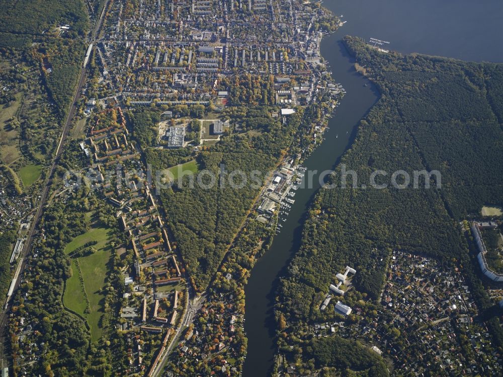 Berlin from above - View of the Friedrichshagen part of the district of Treptow-Koepenick in Berlin. Several sports facilities, appartment blocks and estates and commerce areas are located on the Mueggelspree river, in the East of the district which joins the lake Mueggelsee. Fuerstenwalder Damm Street borders Friedrichshagen in West, the Mueggelsee Dam takes its course along the riverbank in the South. The centre of Friedrichshagen is Boelsche Street