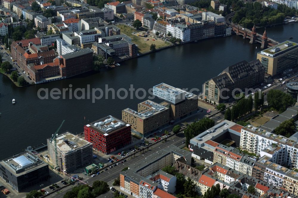 Berlin from above - View of the area around Oberbaumbruecke and course of the river Spree in the district of Friedrichshain-Kreuzberg in Berlin. Several historic and modern business and office buildings as well as apartment buildings are located around the riverbank