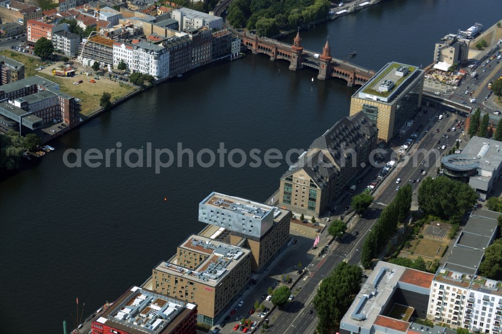 Berlin from above - View of the area around Oberbaumbruecke and course of the river Spree in the district of Friedrichshain-Kreuzberg in Berlin. Several historic and modern business and office buildings as well as apartment buildings are located around the riverbank