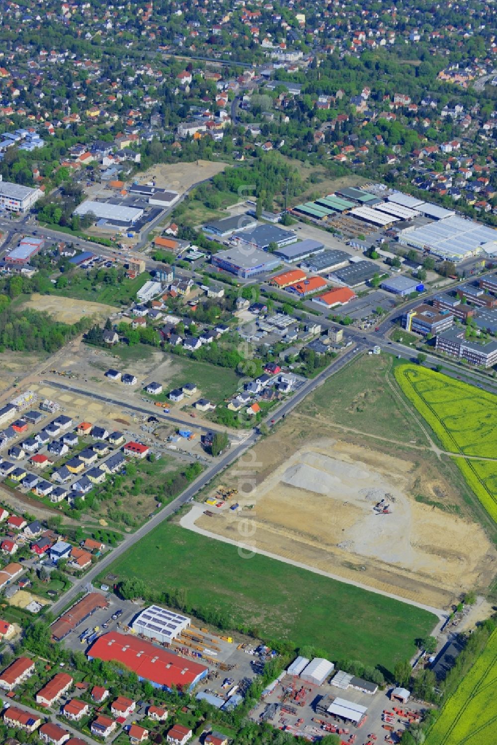 Berlin from above - View of Mahlsdorf around Pilgramer Strasse and the federal highway B1 and B5 in the Mahlsdorf part of the district of Marzahn-Hellersdorf in Berlin in Germany. The site is located opposite single family homes and is surrounded by fields and meadows. It is supposed to become a furniture store