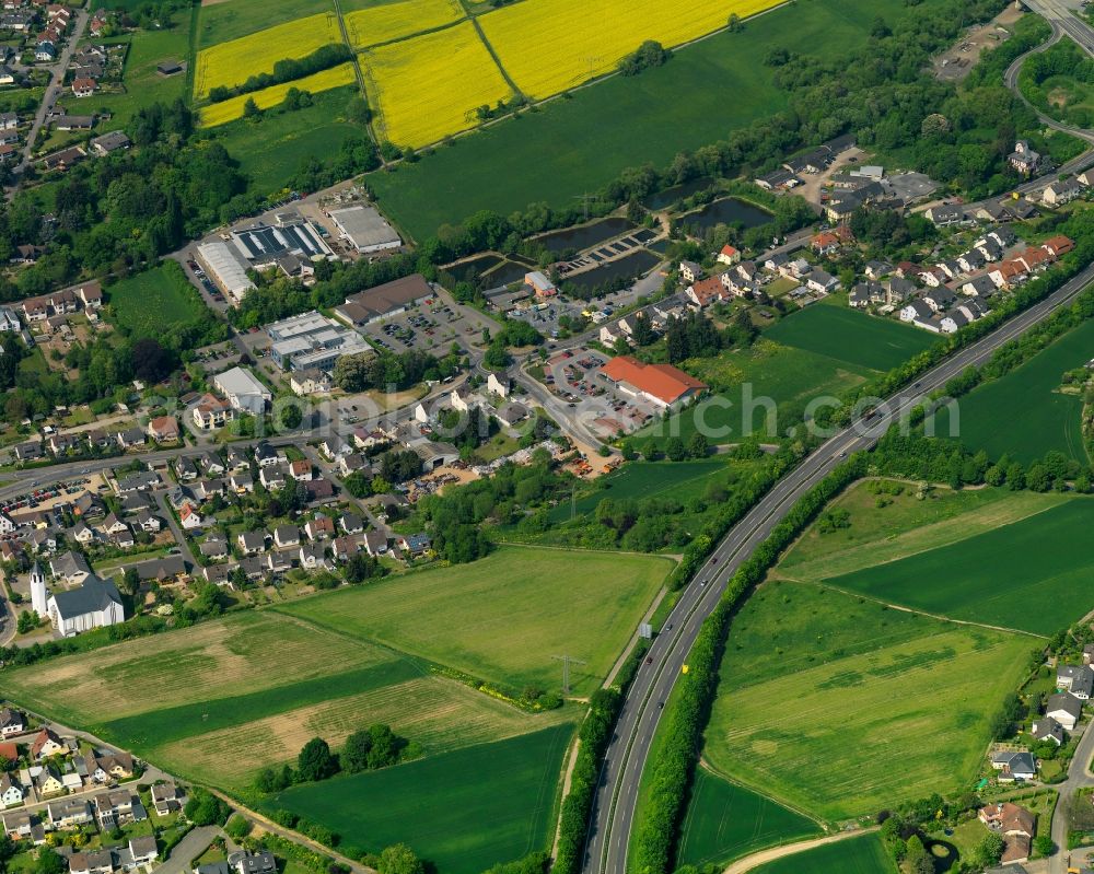 Neuwied from above - View of the Niederbieber part of the town of Neuwied in the state of Rhineland-Palatinate. The town is located in the county district of Mayen-Koblenz on the right riverbank of the river Rhine. The town is an official tourist resort and is an important historic industrial site. Niederbieber is located in its Northwest, surrounded by meadows and rapeseed fields on the edge of the Nature Park Rhine-Westerwald, adjacent to the federal highway B256